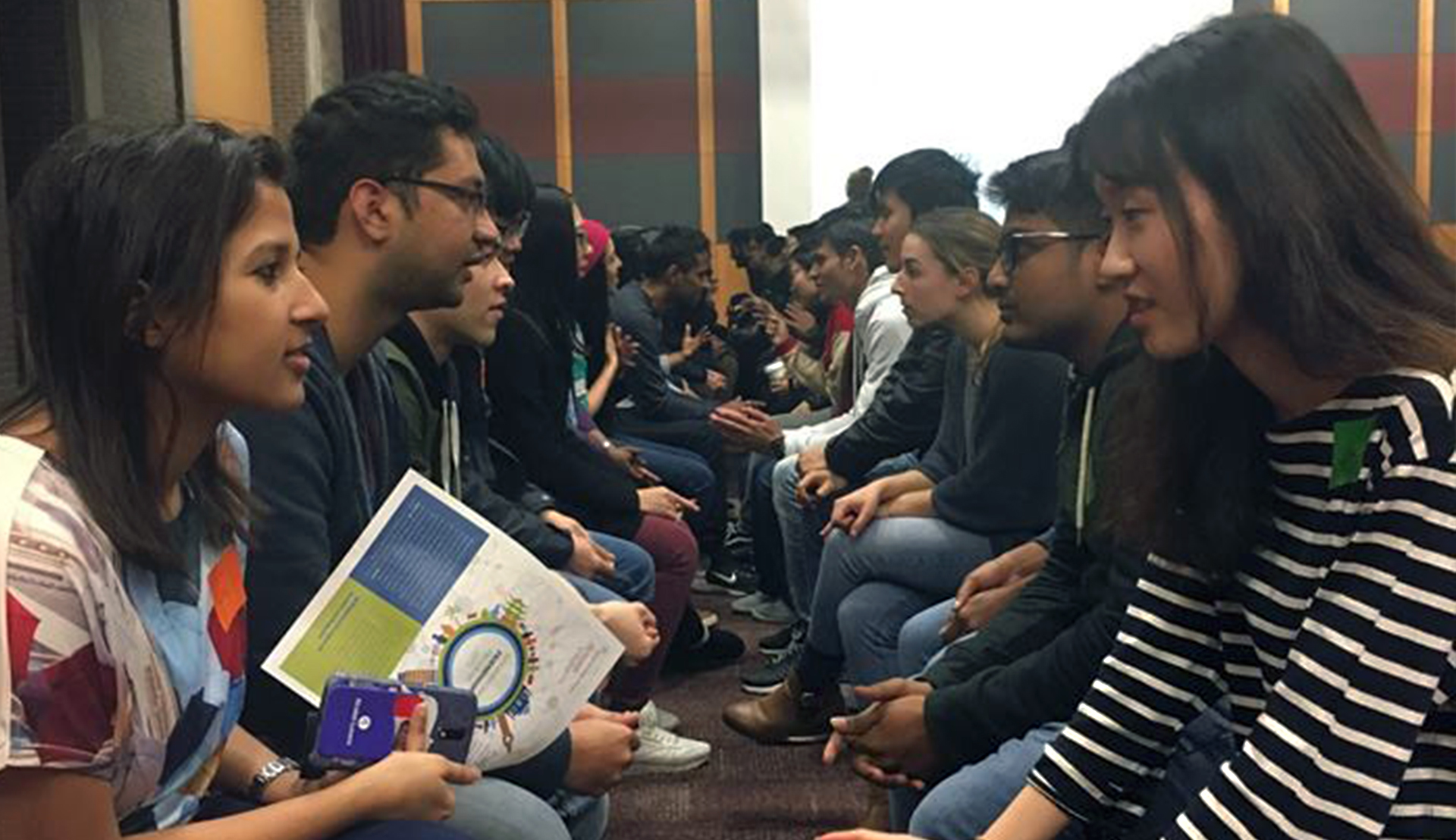 Rutgers Global - International Friendship Program Speed Friending, two long rows of American and international students face each other for five-minute revolving conversations in the College Avenue Student Center