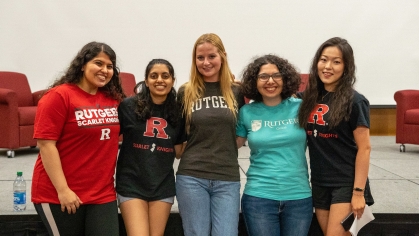 Five students wearing Rutgers shirts at event