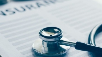 Stock image with health insurance form, calculator, stethoscope