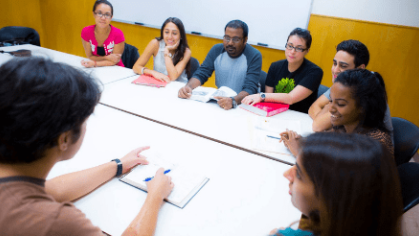 student group sit around a table discussing