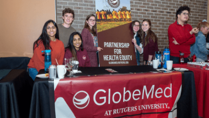 a group of student presenting a stand of global meds