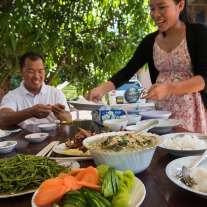 woman and man serving food on the table