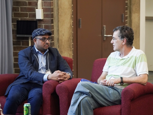 Two Rutgers international scholars talk at a reception