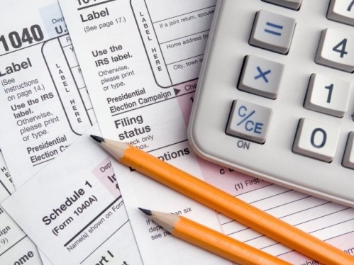 Stock image with tax forms, calculator, pencils