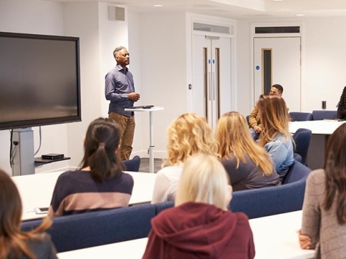 man speaking in front of a class