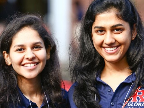 two rutgers students smile at camara