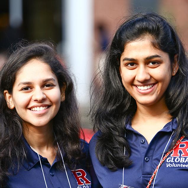 Rutgers Global – Postarrival Guide, two international student volunteer pose and smile during International Student Orientation