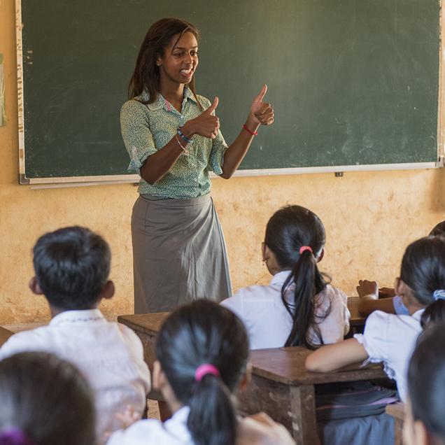 Rutgers Global – Peace Corps Job Types, Peace Corps volunteer teaching a classroom of children