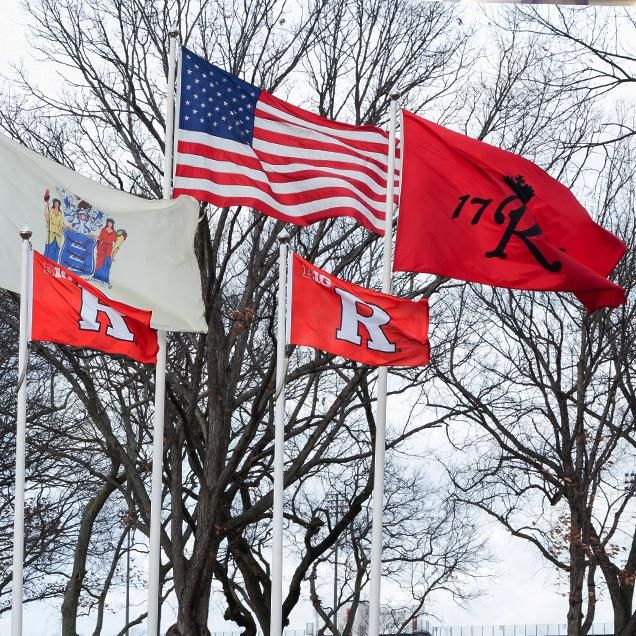 Rutgers Global - Requesting F-2 or J-2 Documents for Dependents of International Students, five flags wave in wind against bare trees: New Jersey state flag, American flag, Rutgers 1766 flag, two Rutgers "R" flags.