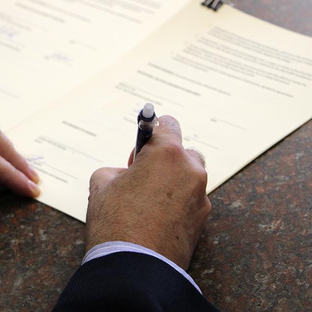 Rutgers Global – International Partnerships, hand signing document