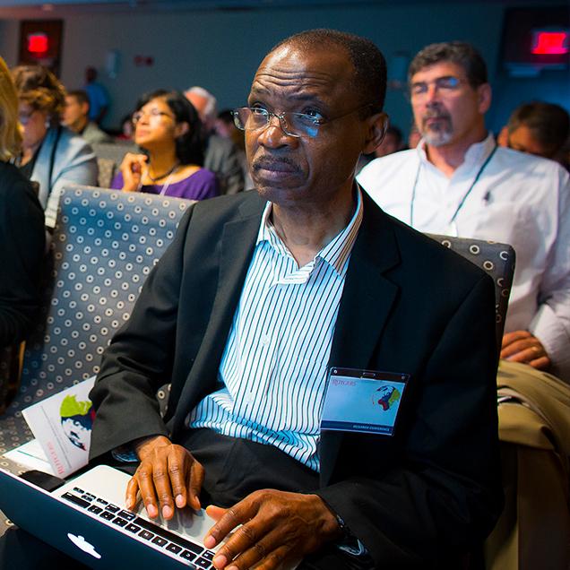 Rutgers Global – Programs and Opportunities, attendee with laptop listens to a speaker at the International Research Conference
