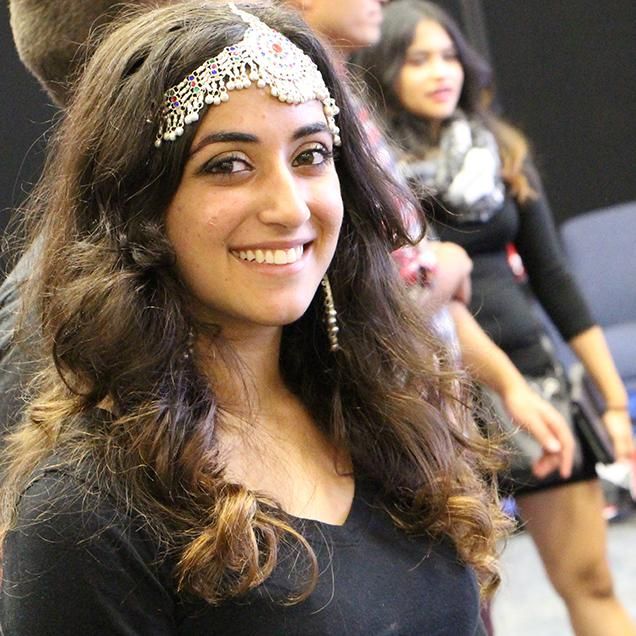 Rutgers Global – Programs and Events, a student exhibitor dons traditional headdress during the 2015 International Festival
