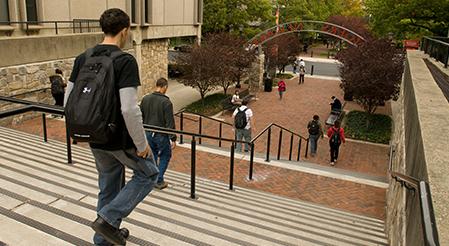 Rutgers Global - CLiME, student descends large set of steps outside on Rutgers-Newark campus 